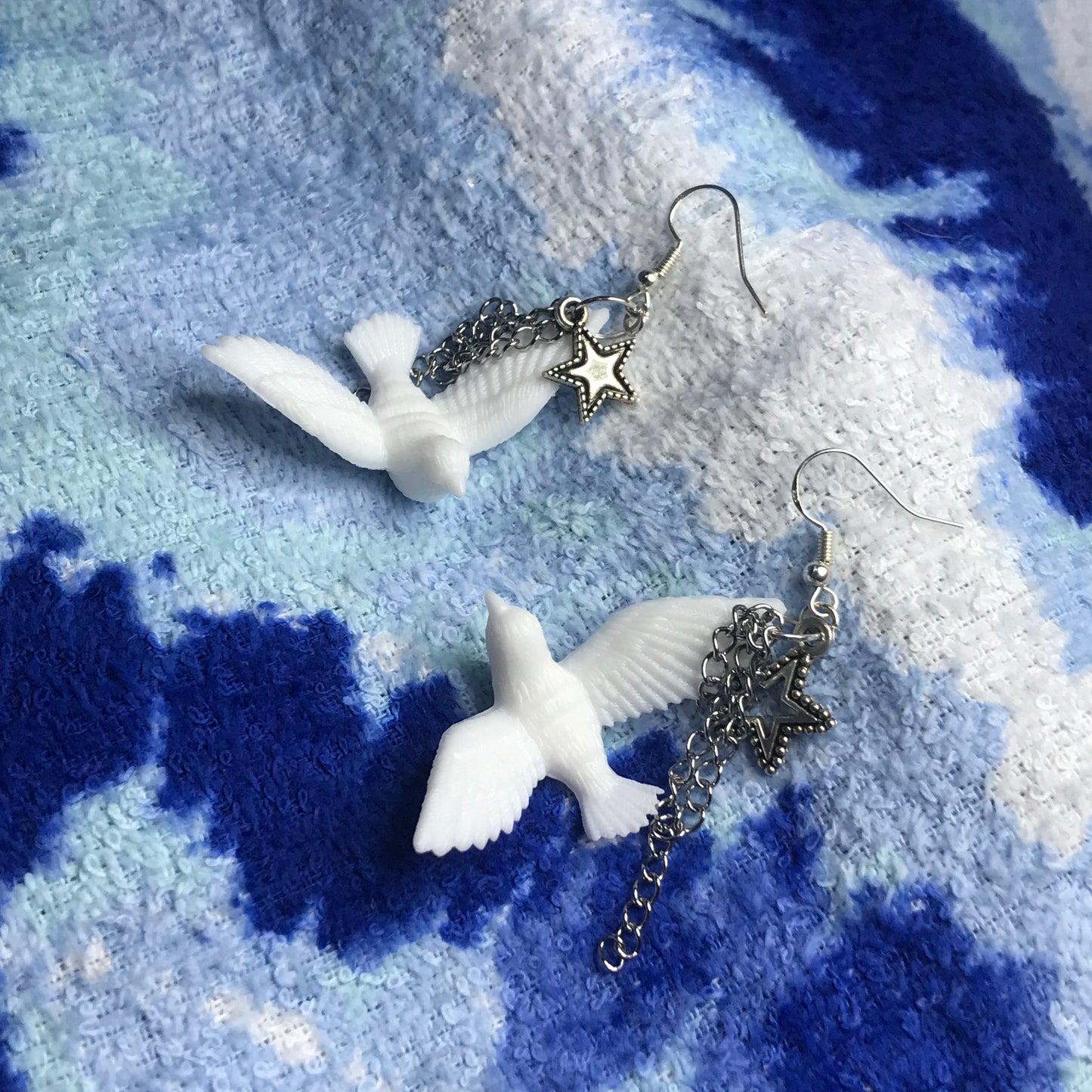 chained star dove earrings