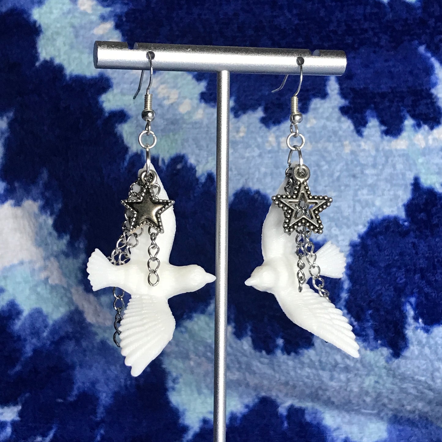 chained star dove earrings